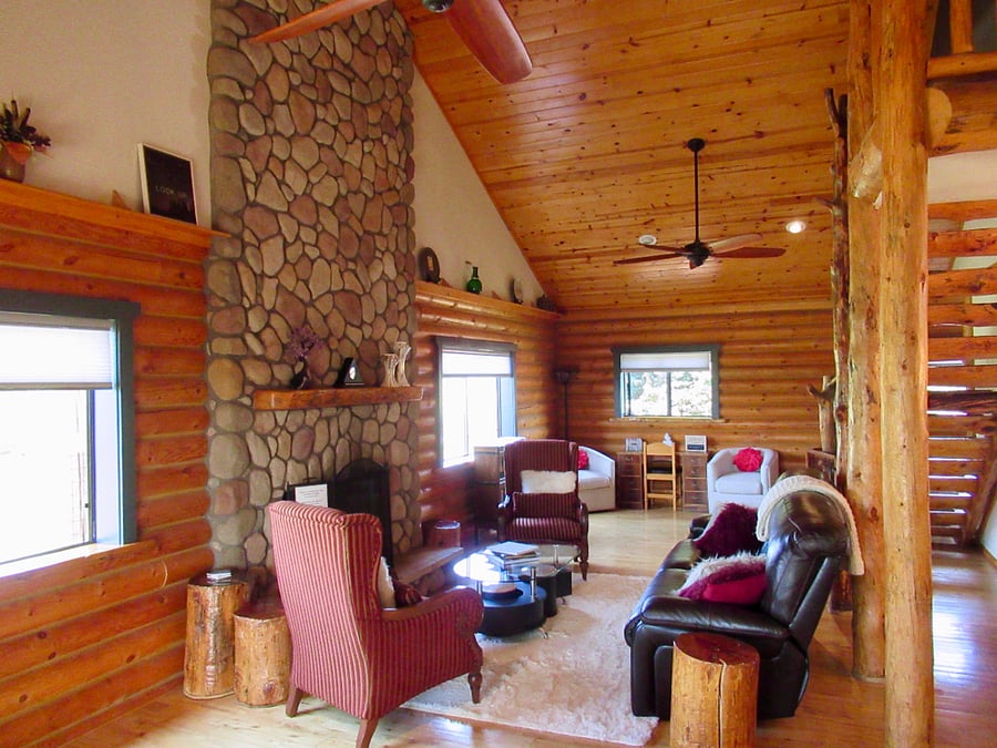 Living room space with gas fireplace, TV and desk.