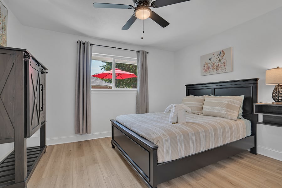 Guest bedroom with queen and half bath across the hallway