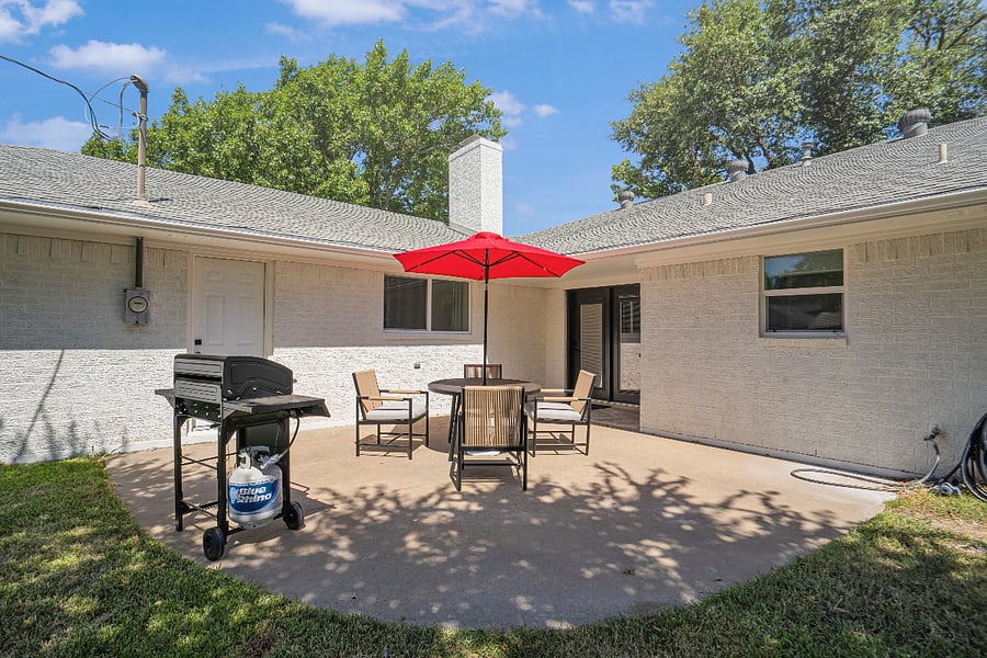 Patio with covered seating and grill