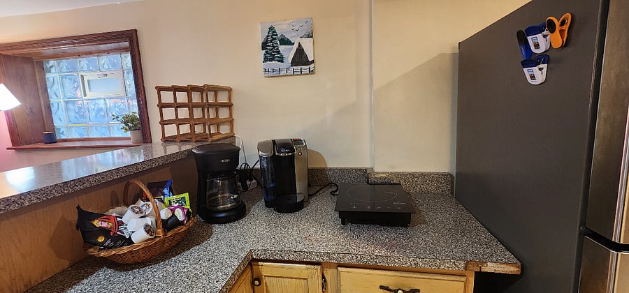 Breakfast station includes both drip and Keurig coffee makers, a tea kettle, and various coffee and tea selections