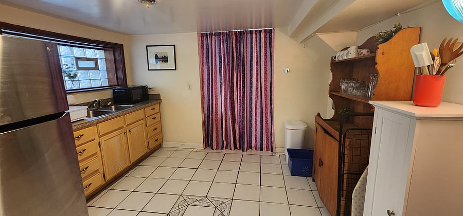 Kitchenette space with privacy curtain separating the apartment