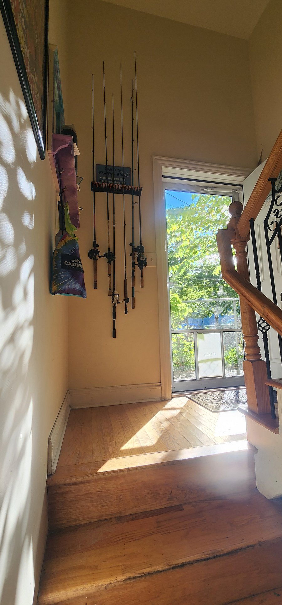 Staircase leading to back door and separating the basement from the ground floor level