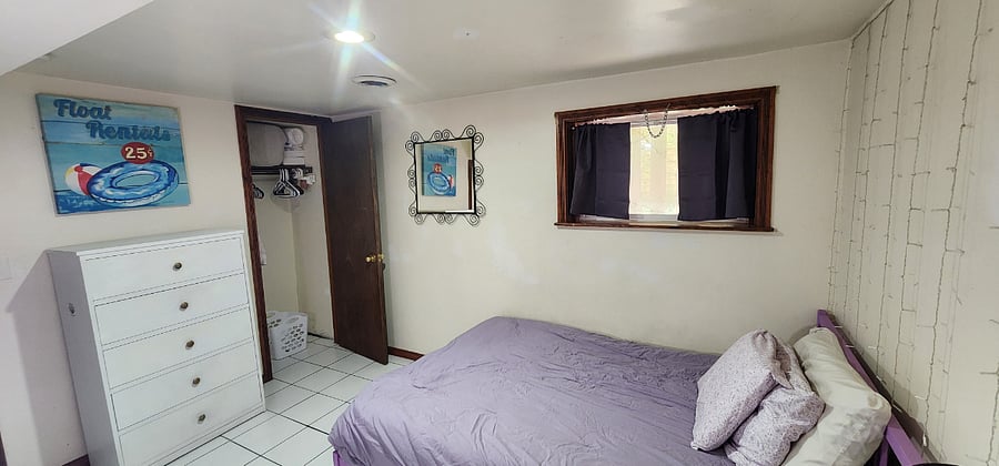 Closet contains hangers, laundry basket, extra bedding and towels, and other amenities