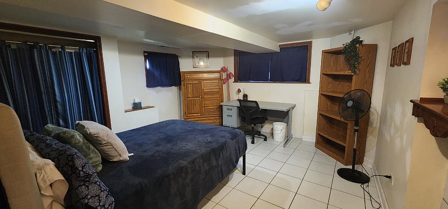 Largest bedroom with Queen bed, ample closet space, desk, nightstand and dresser