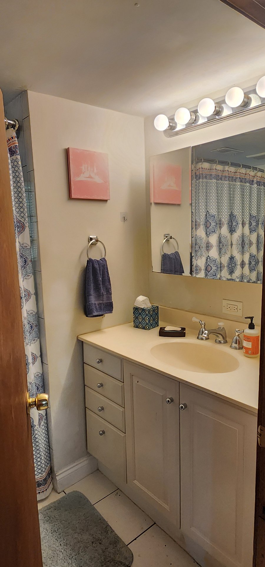 Full-sized bathroom with tub-shower combo, includes plenty of amenities