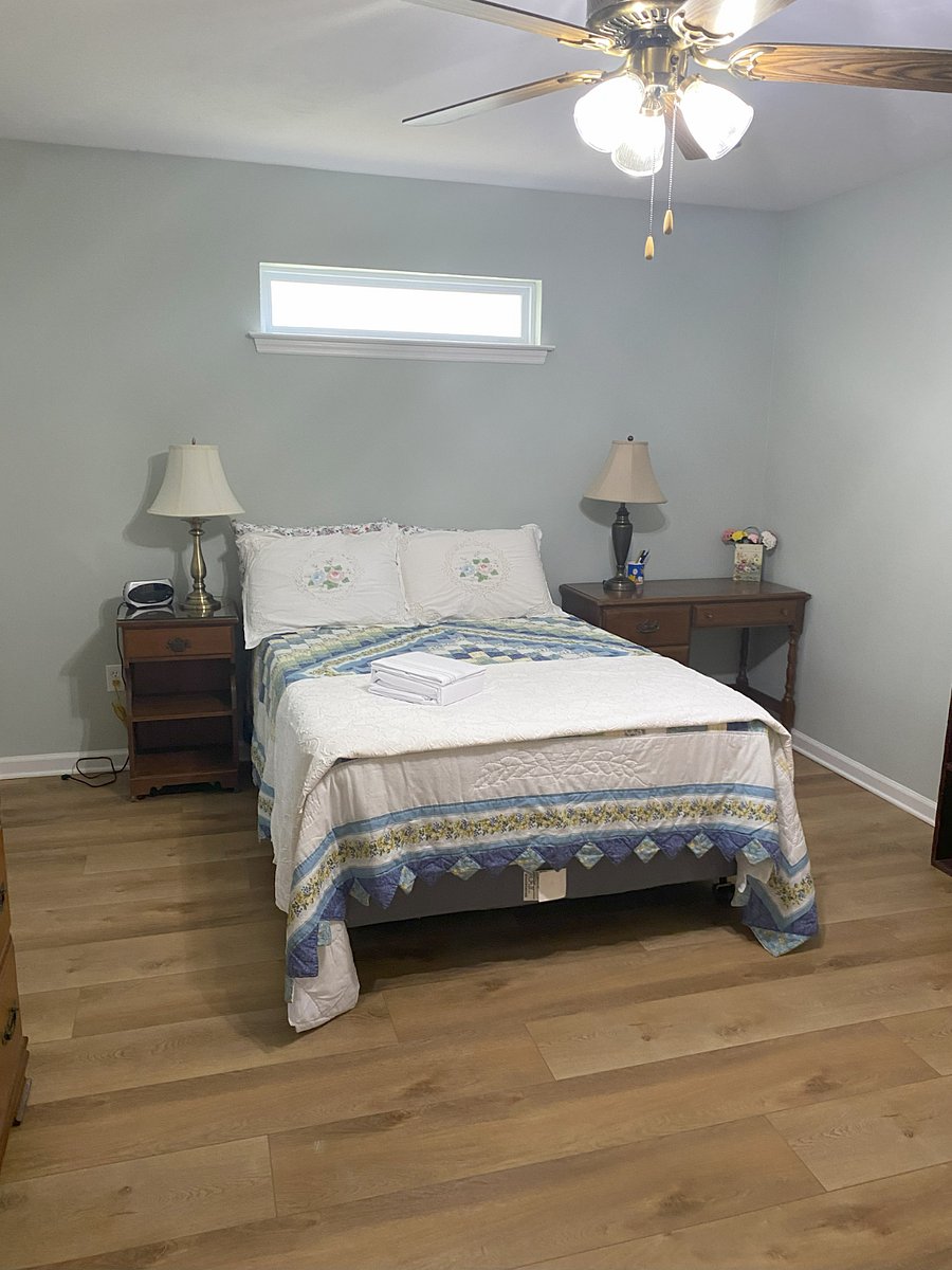 Bedroom with dresser, chest of drawers, bookcase, and desk