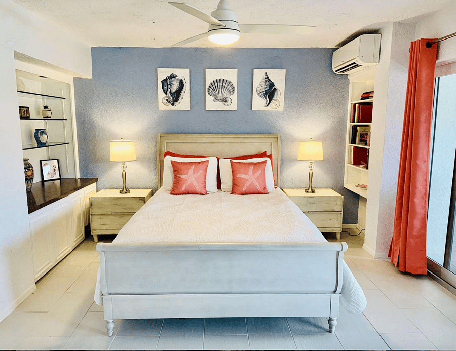 Oceanview queen bed with french barn doors into the family room.  