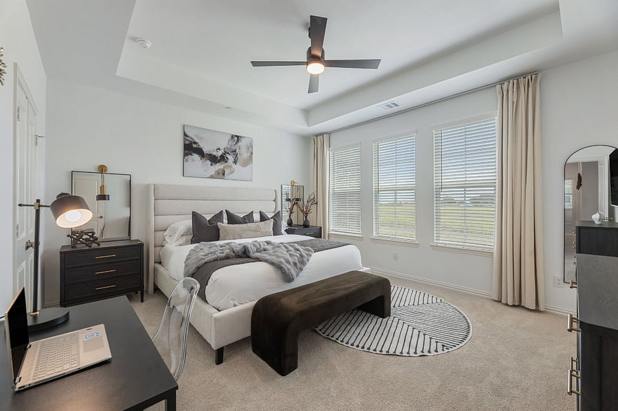 Luxurious Master Bedroom with 10ft ceilings and lots of natural light. Features a 65" Smart TV, walk-in His and Hers closets, and a dedicated workstation.