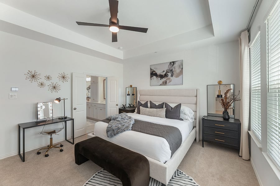 Luxurious Master Bedroom with 10ft ceilings and lots of natural light. Features a 65" Smart TV, walk-in His and Hers closets, and a dedicated workstation.