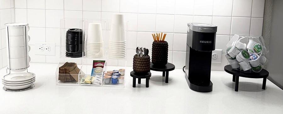 Coffee, tea and hot cocoa bar with honey, 3 different types of creamer and to-go cups, sleeves and lids for convenience.