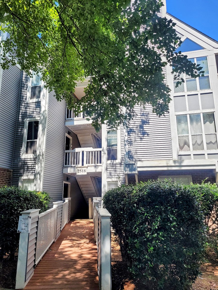 Exterior of the Villages of Eastover Glen condos surrounded by wooded and green spaces