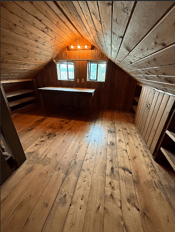 Versatile loft with large table/desk and deep storage cabinets. Use for office space, storage, or guest room..