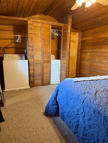 Bedroom includes working washer and dryer as well as closet space and hooks.