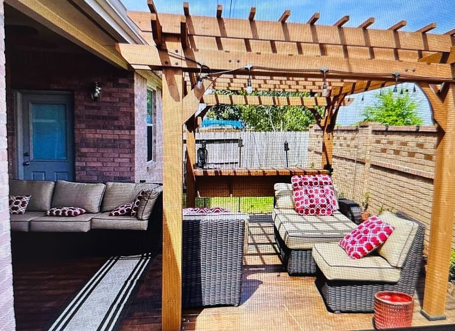 Shared outdoor space features relaxing chairs and outdoor TV