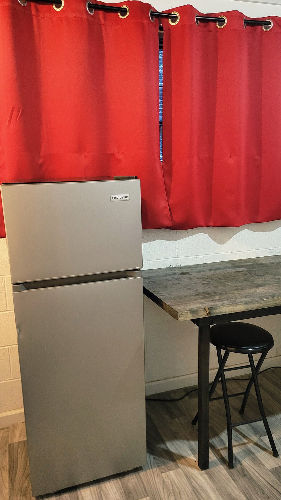 Kitchenette/Laundry Room with 7.5 cu ft. refrigerator.  Window view of the guest's parking area.