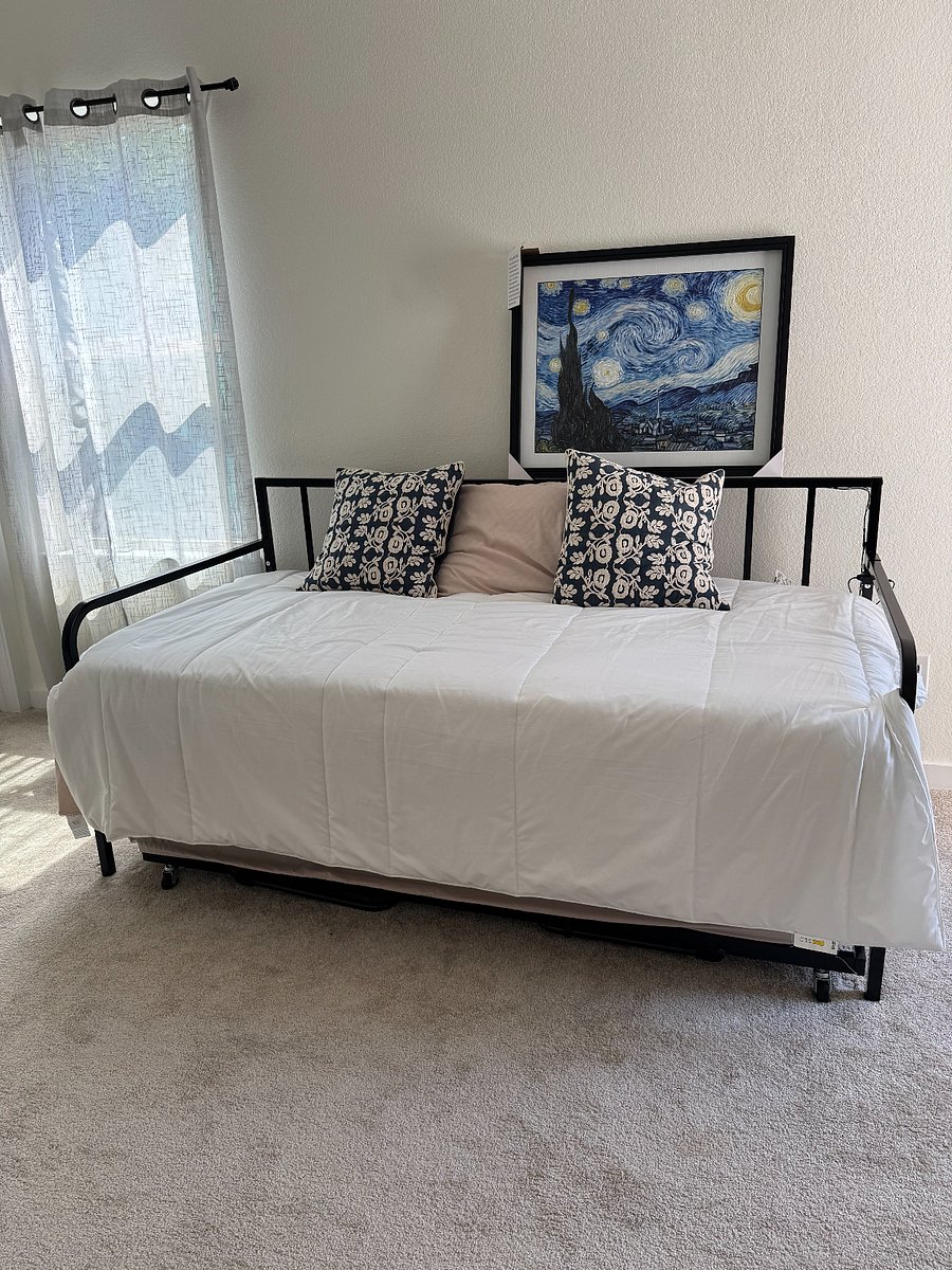 Loft includes a pull out trundle bed by balcony door and natrual lighting.