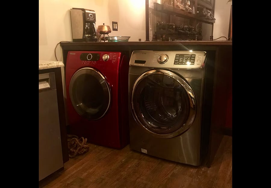 The washer and dryer are located in the kitchen. They are underneath the countertop that separates the living room from the kitchen.