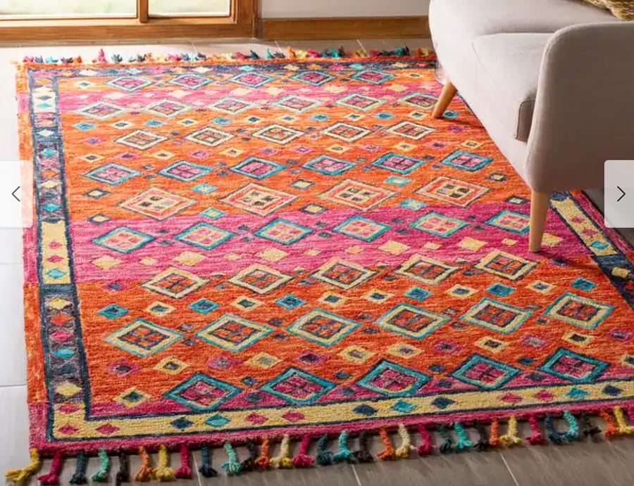 A new handmade Aspen Dona Boho Tribal Wool rug adds a splash of color to the living room area.
