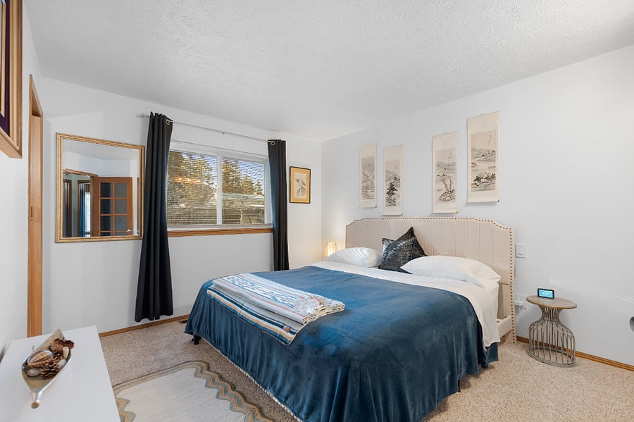 This south-facing master bedroom features a king-size bed with an Asian flair, plenty of lighting, and a Google clock to wake up to your favorite artistperfect for singing along in the shower.