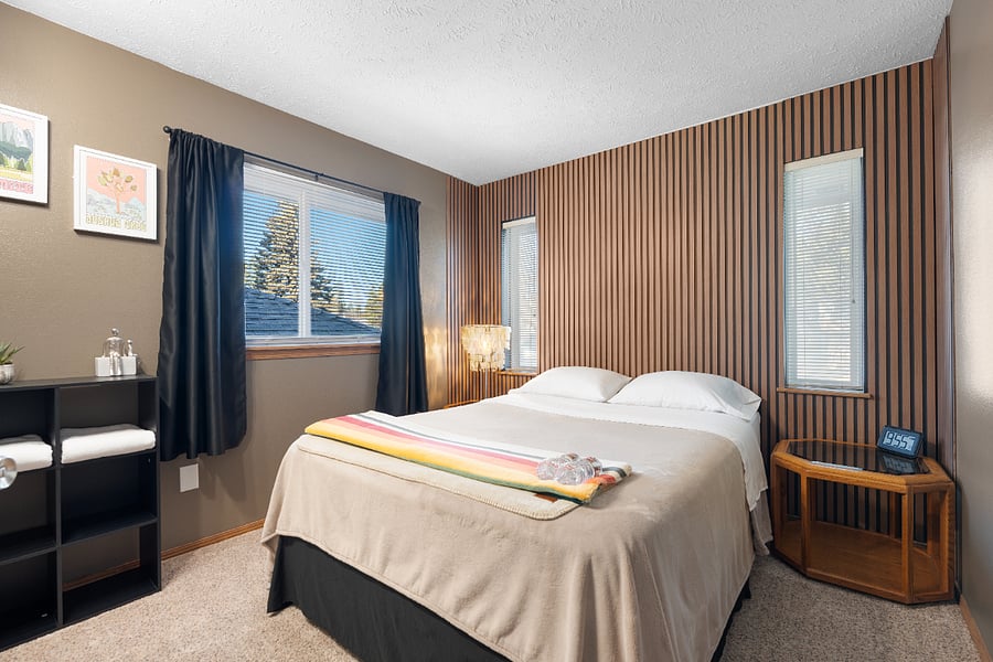 This unique room features a queen bed, room-darkening curtains and blinds, clothing storage, and ample closet space with hangers.