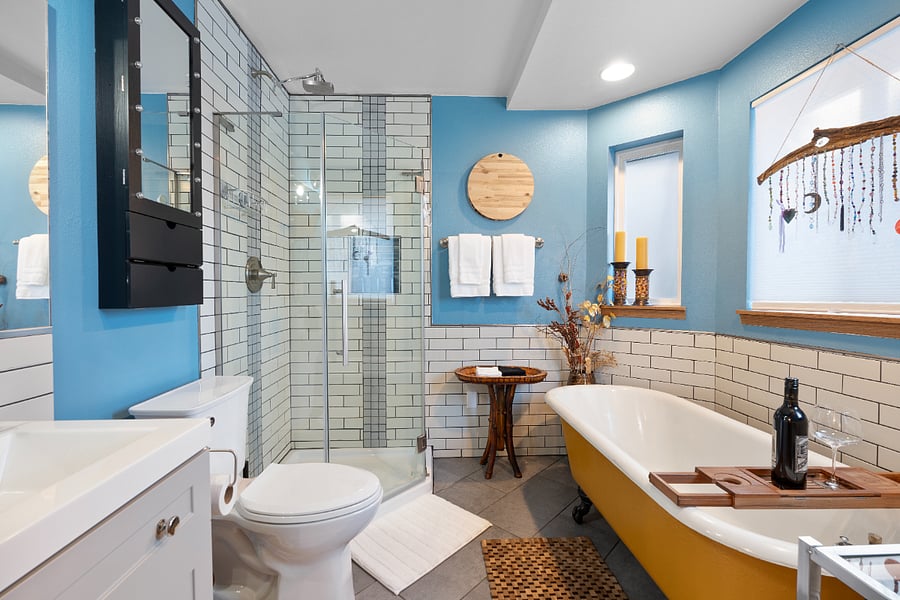 This one-of-a-kind master bath features a ceramic clawfoot tub, a shower with views of the backyard, and complimentary shampoo, conditioner, and body wash.
