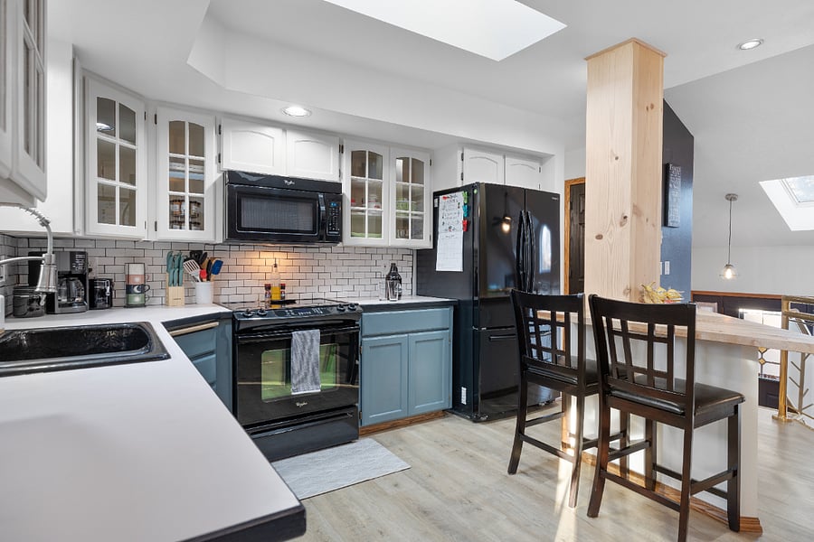 Equipped with a convection Whirlpool oven, a Whirlpool microwave, and a Samsung refrigerator, this kitchen has everything you need to whip up something special.