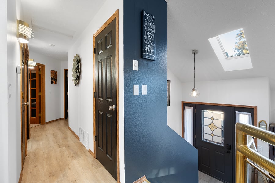From the kitchen, you'll enter the sleeping quarters, which include the main bathroom, master bathroom, king room, queen room, twin room, linen closet, and coat closet. The coat closet is equipped with a vacuum, broom, dustpan, and Swiffer.