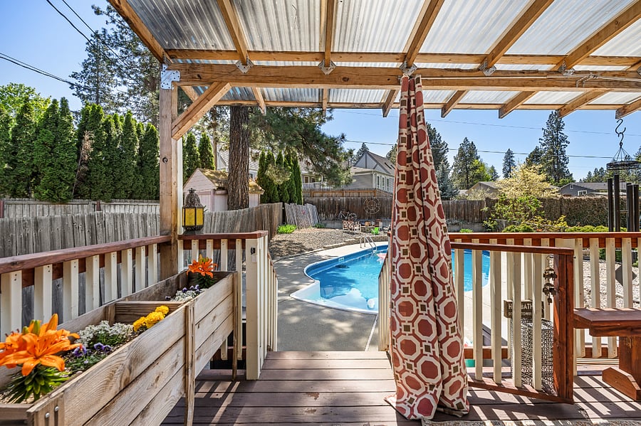 Enjoy the southern sun on this covered back deck, overlooking the backyard and pool.
