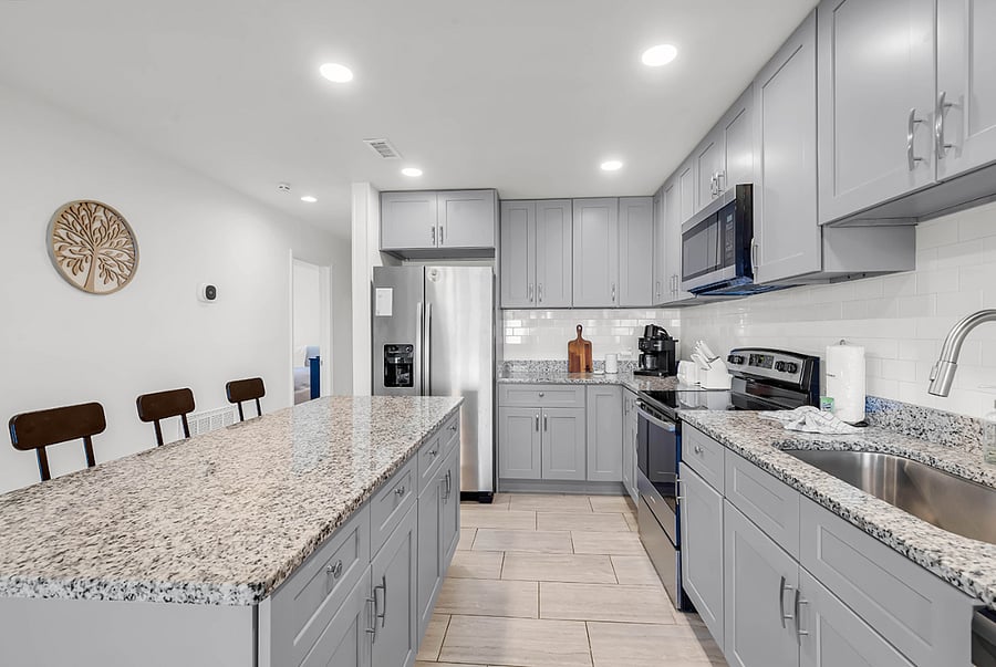 Modern kitchen with stainless appliances, Keurig for hot or iced coffee, and custom Sea House Villas touches.