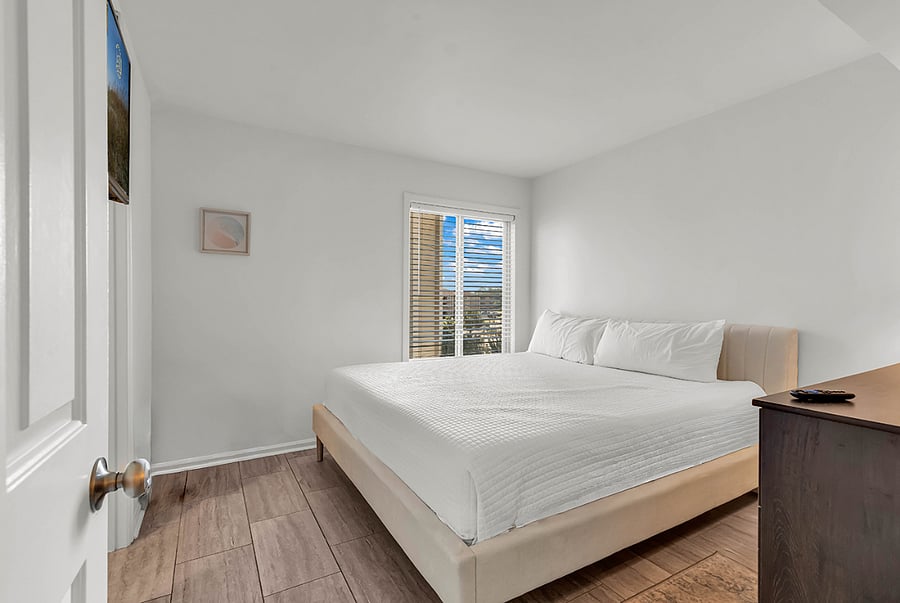 Guest bedroom with premium king mattress and Smart TV for restful nights by the coast.