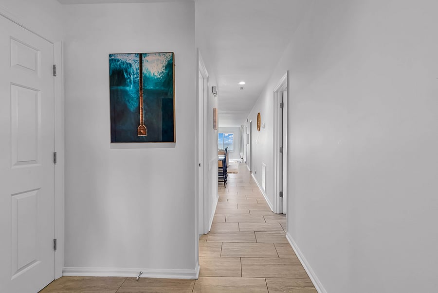 Inviting entry and open floor plan with curated art for a warm, coastal welcome.