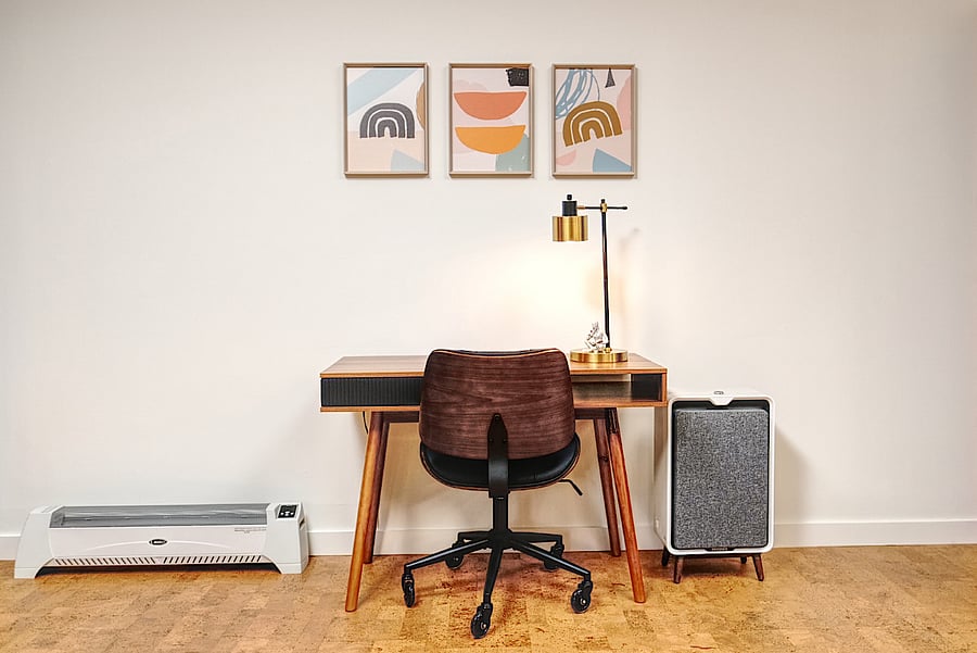 Desk area includes an electric baseboard heating and air filter.