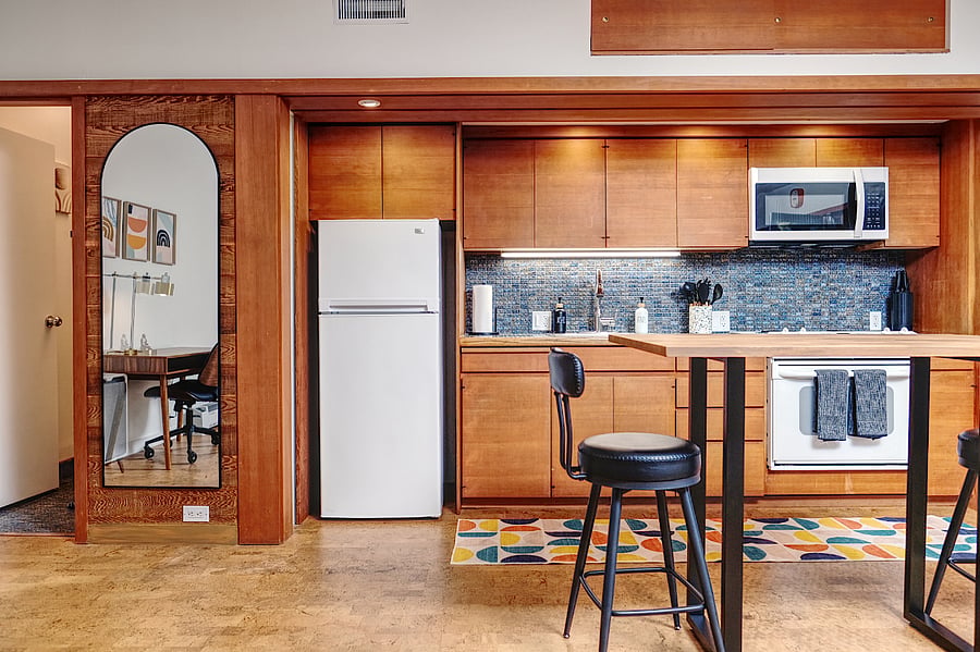 Additional storage is located above cabinets for storing larger items. Step ladder and step stool are provided.