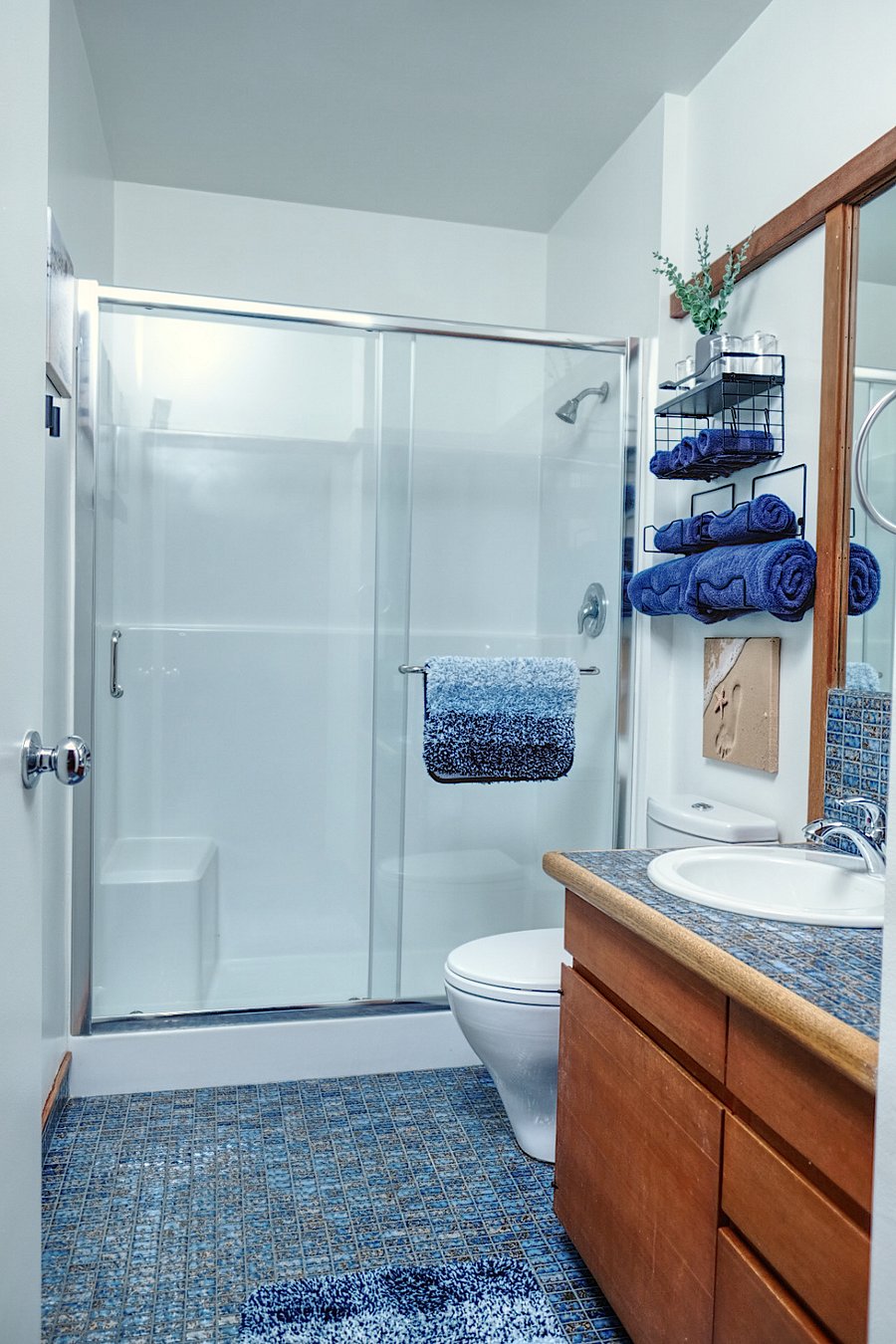Wall hooks are included to hang towels and robes.
