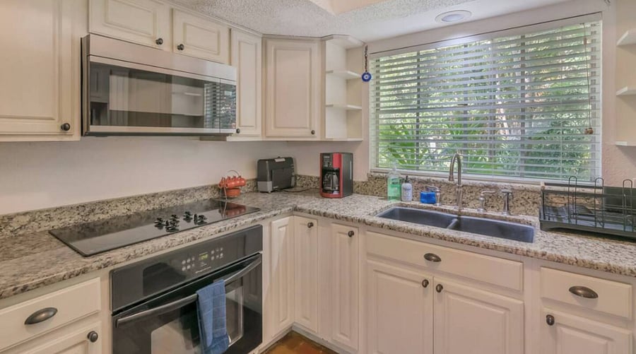 The full kitchen has a dishwasher, oven, stove top, microwave & refrigerator. A Brita water jug in the fridge and a countertop ice maker. It is fully stocked with pans, glassware, dishware & utensils.