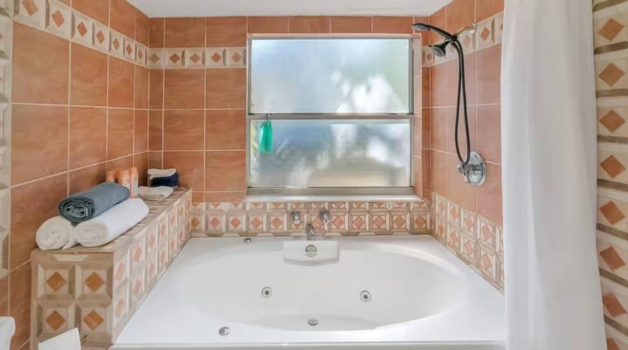 The full bathroom on the ground floor unit consists of a sink, large counter top, toilet and whirlpool tub with shower. Towels, shampoo, conditioner and soap are provided.