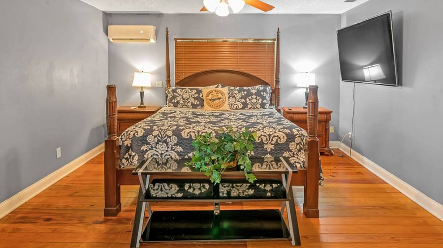 The ground floor bedroom contains a king size bed. There is also a desk and office chair.