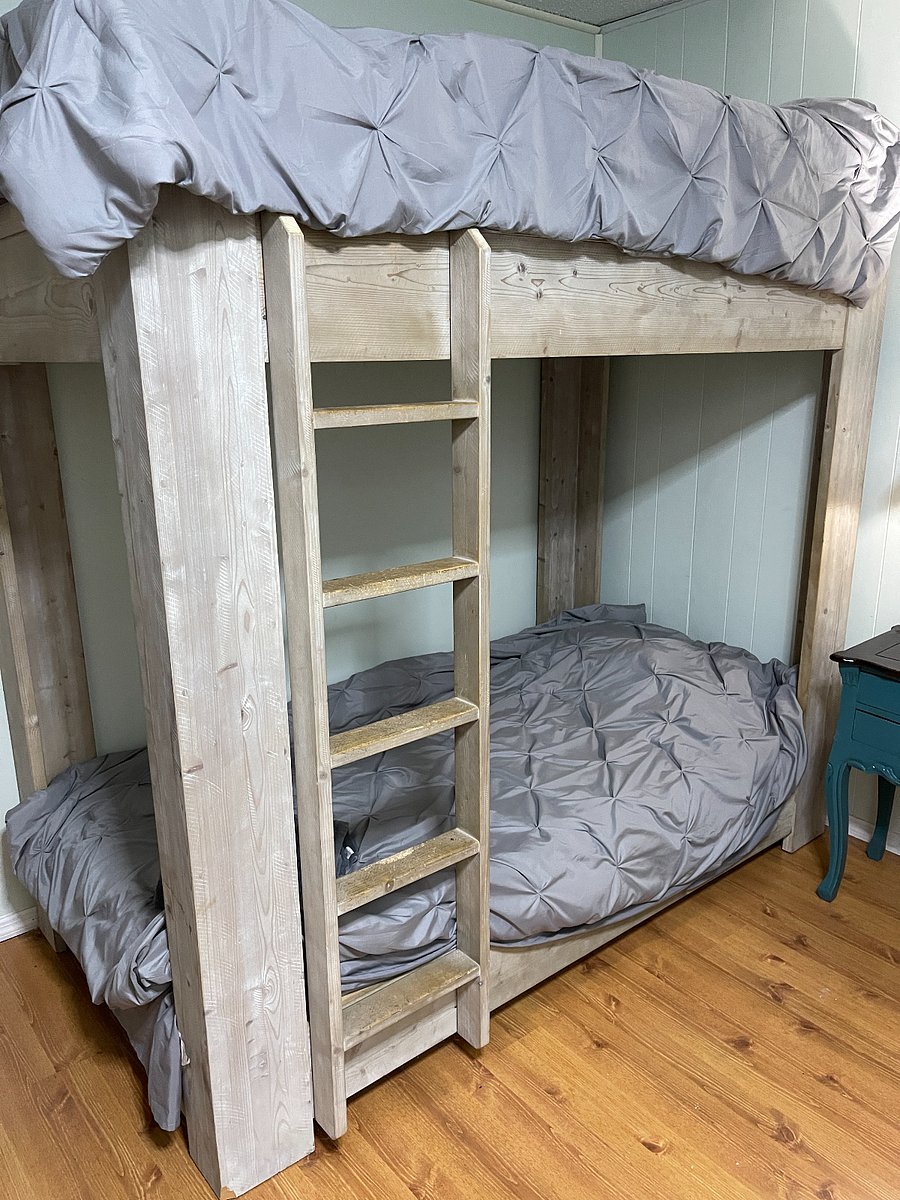 Bedroom 3 is located on the 2nd floor and consists of twin size bunk beds, side table with a lamp and an armchair. This bedroom has its own window a/c unit, a closet with hangers & tv.