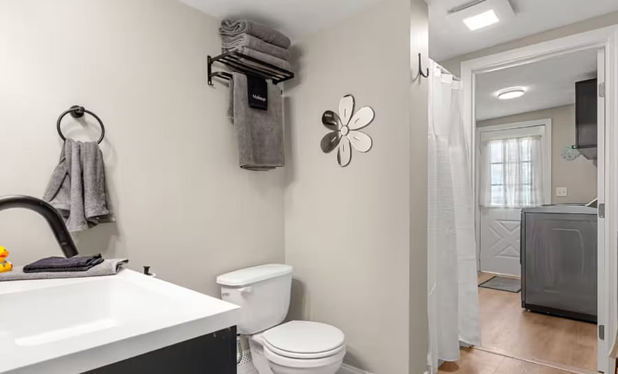 Bathroom is adjacent to the brand new laundry room with fast machines