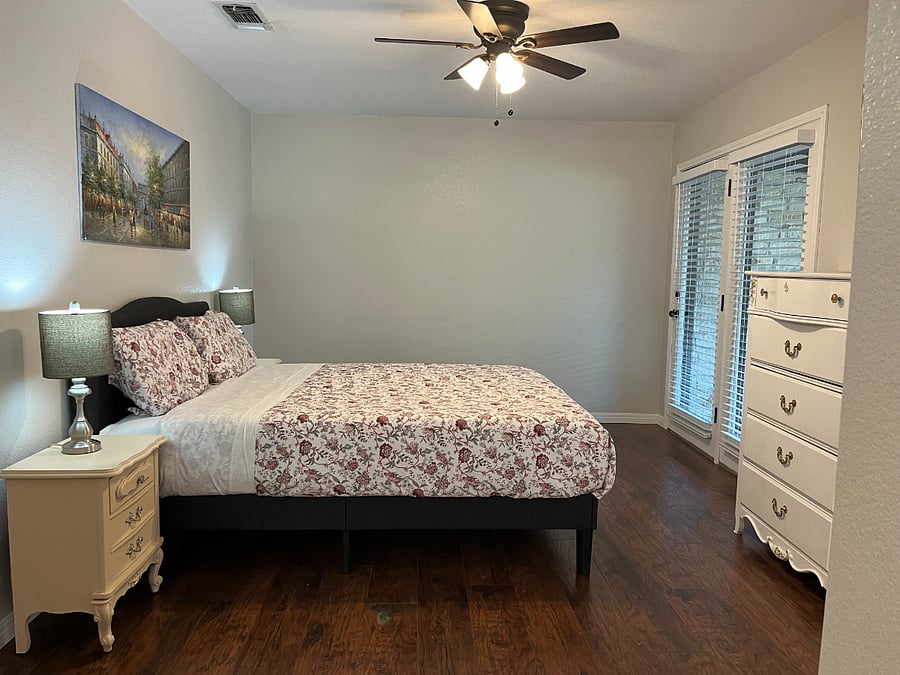 Master bedroom with doors out to back porch & yard