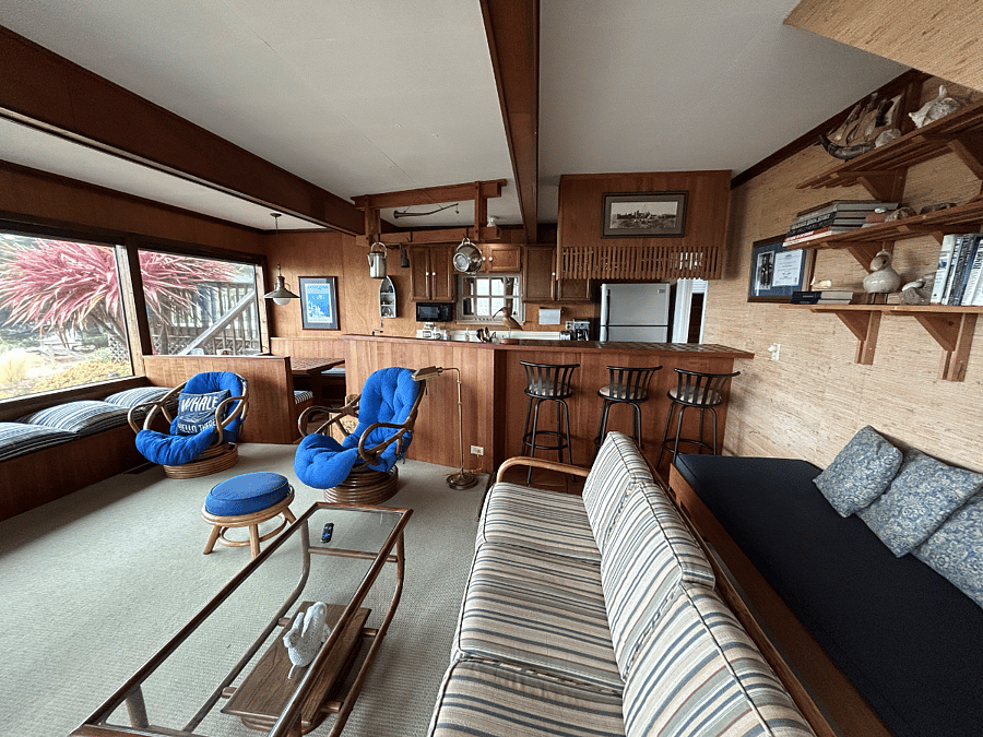 Living room and kitchen with built in booth dining as well as counter dining.