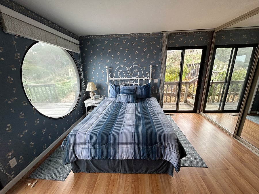 Second level bedroom with outdoor access to the back deck.