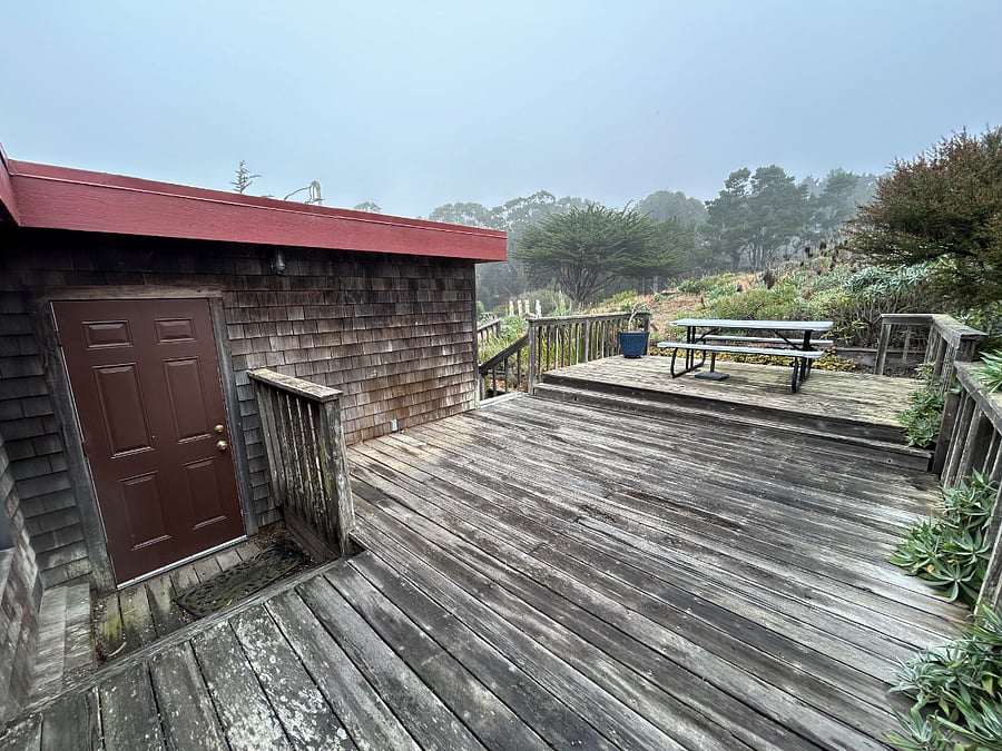 Back door access to back deck and outdoor dining area with ocean view.