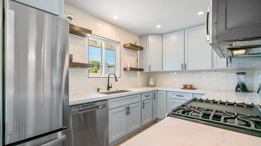 quartz countertops with waterfall edge, custom cabinetry, l2 azy susans for extra storage and subway tiles.