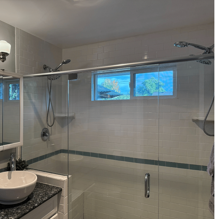 Large walk-in shower with shower heads on both ends including rain heads & spray wands.