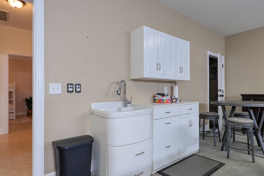 Utility sink with storage and counter space for your convenience.