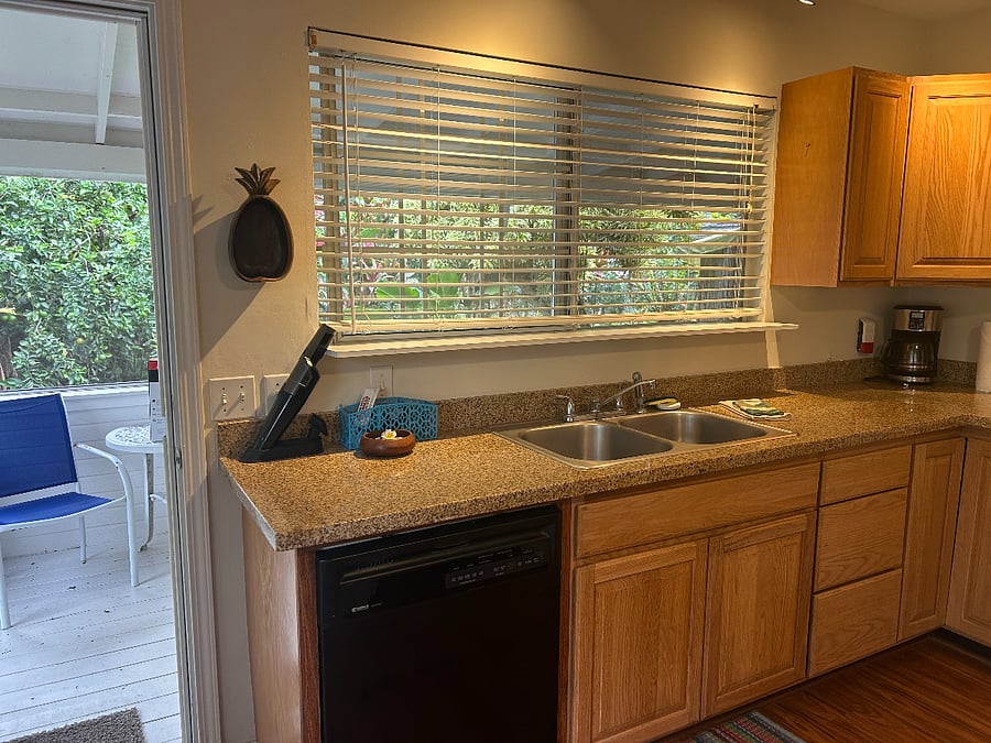 Kitchen window opens to lanai and garden view