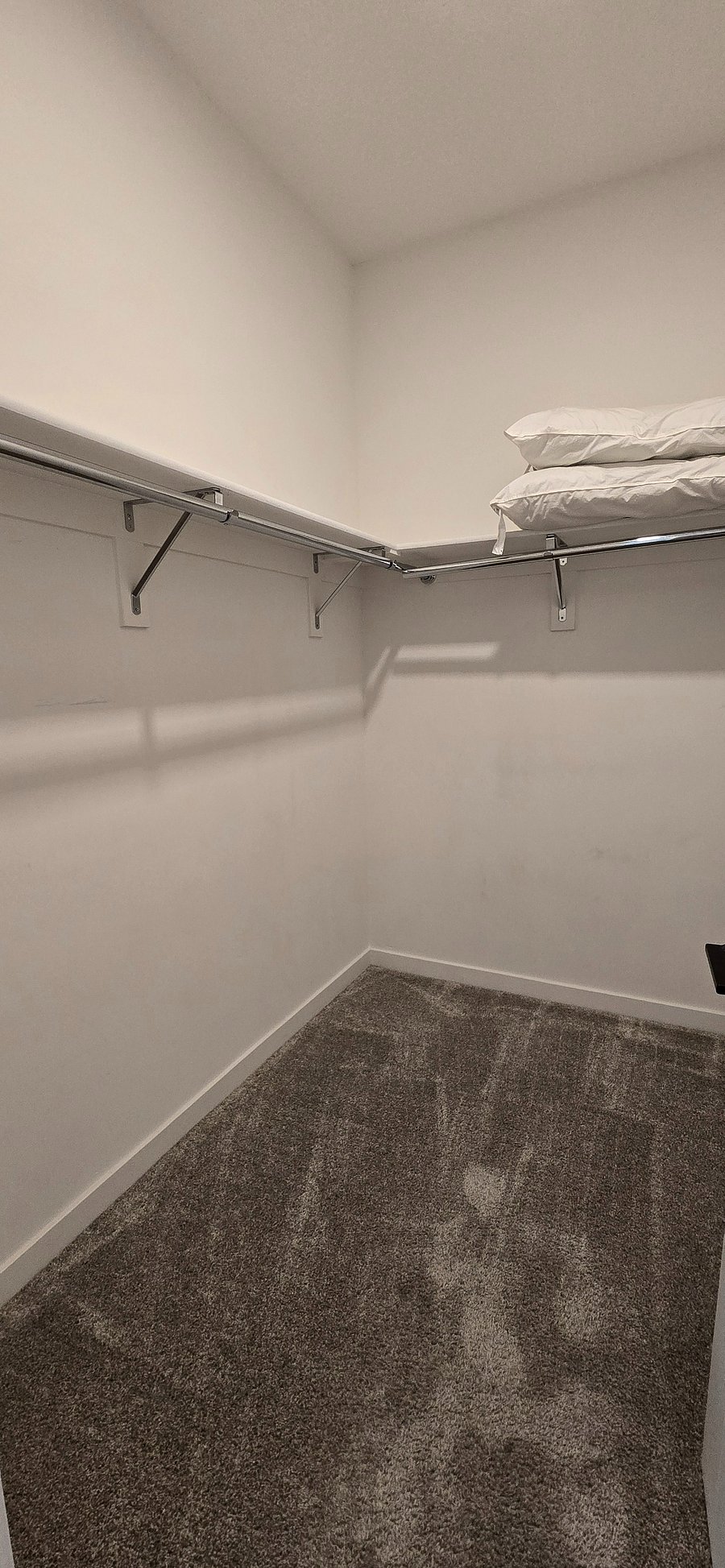 Primary bedroom walk-in closet
