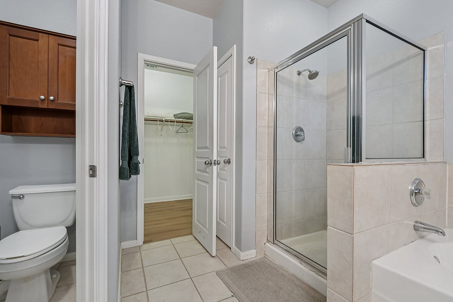 Master bath with shower, tub, and walk in closet