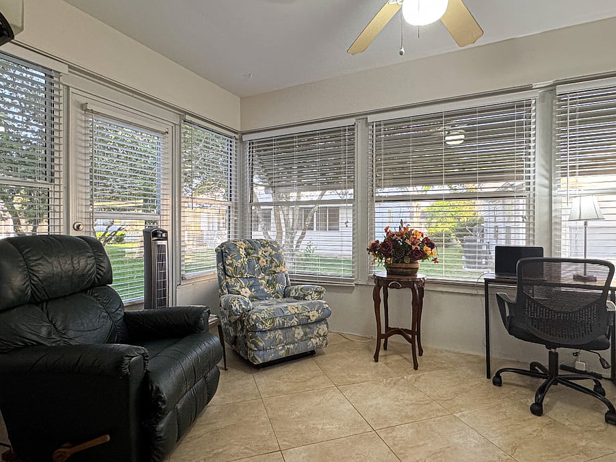 Florida Room/Third Bedroom/Office with twin bed has access to the backyard and patio. Two recliner chairs makes it a wonderful space for reading or conversation.  Computer desk and comfortable chair great for laptop work while vacationing.